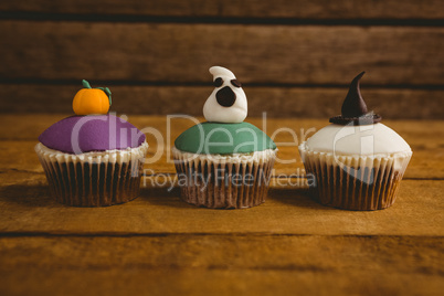 Close up of Halloween cup cakes arranged on table