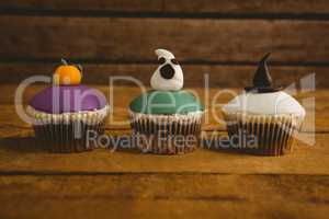 Close up of Halloween cup cakes arranged on table
