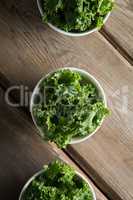 Overhead view of kale arranged in bowls on table
