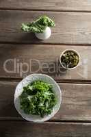 Overhead view of fresh kale in containers on table