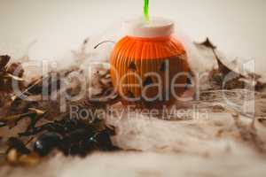 Jack o lantern container with autumn leaves and decoration