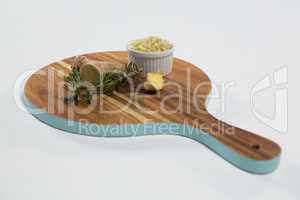 High angle view of rosemary and ginger on wooden serving board