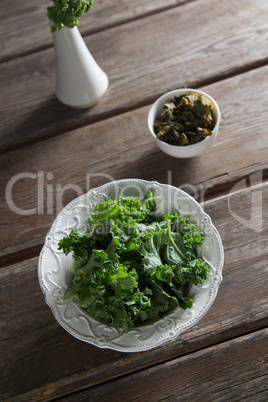 fresh kale in plate on table