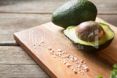 Avocado and rock salt on cutting board