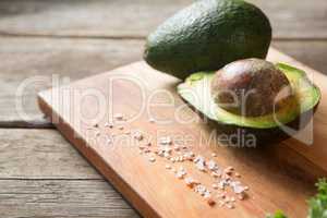 Avocado and rock salt on cutting board