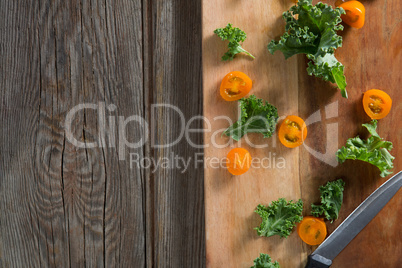 Kale and tomato slices on cutting board
