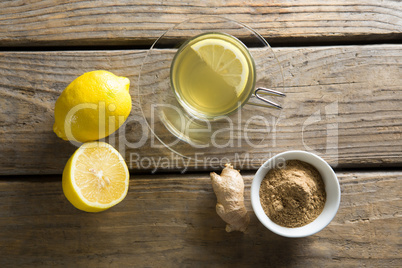 Tea cup with lemon and ginger on table