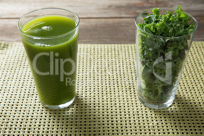 Fresh kale juice and leaves in glasses