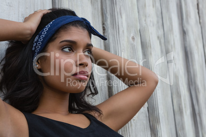 Thoughtful woman with hand in hair