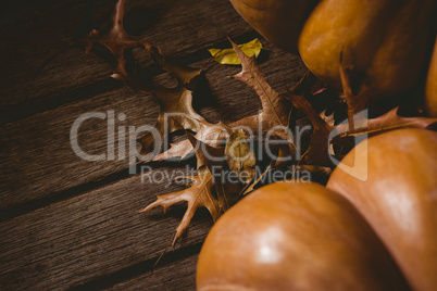 Pumpkin with autumn leaves on wooden table