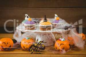 Sweet food on wooden table during Halloween