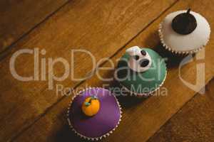 High angle view of Halloween cup cakes arranged on table