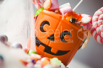 Tilt image of bucket with various sweet food