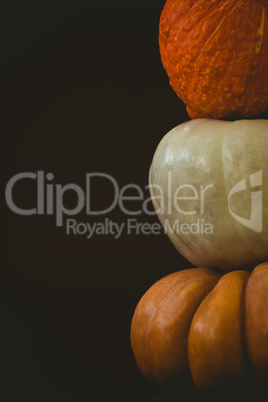 Pumpkins arranged against black background