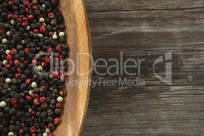 Mix peppercorns in wooden bowl