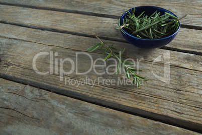 Rosemary in bowl on wooden table