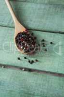 Mix peppercorns in spoon