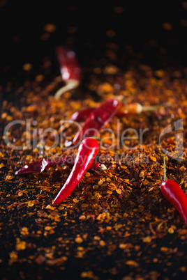 Red chilli flakes against black background
