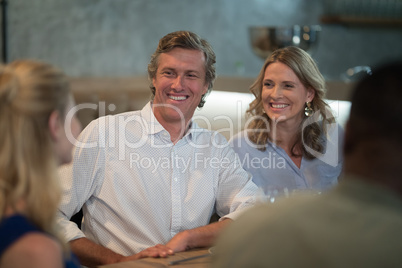 Friends interacting while dining in restaurant