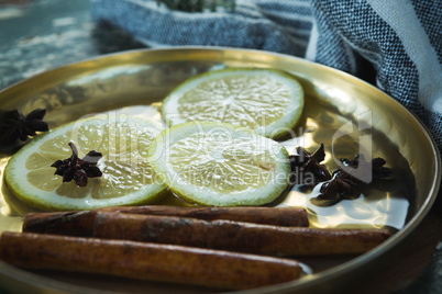 Various spices, spoon and napkin on wooden table