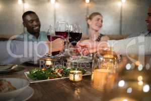 Friends toasting red wine in restaurant
