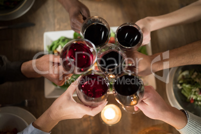 Friends toasting red wine in restaurant