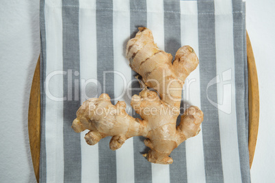 Directly above view of fresh ginger on striped napkin in plate