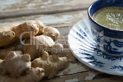 Close up of fresh tea with gingers on table