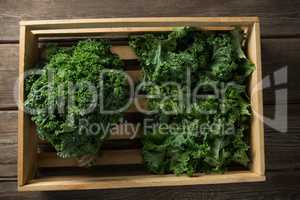 Overhead view of kale in crate on table