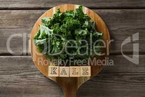 Kale leaves with text blocks on cutting board