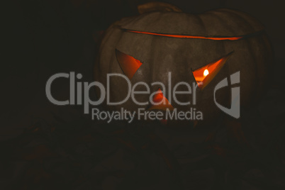 white jack o lantern glowing in darkroom during Halloween