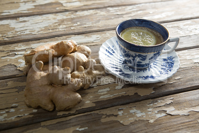 High angle view of fresh gingers by tea with lemon slice on table