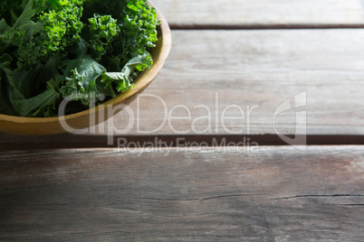 Fresh kale in bowl on table