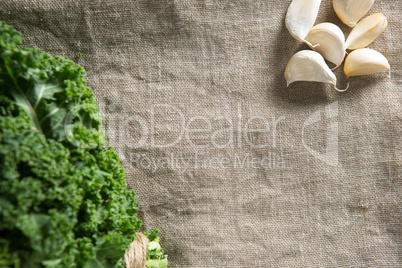 Fresh kale leaves with garlic on napkin