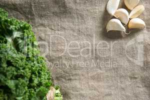 Fresh kale leaves with garlic on napkin