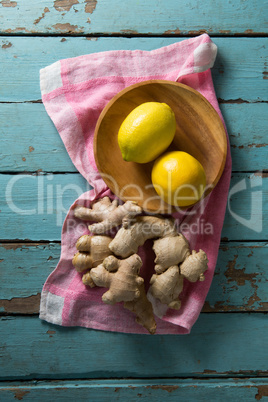 Close up of lemon and ginger with napkin on table