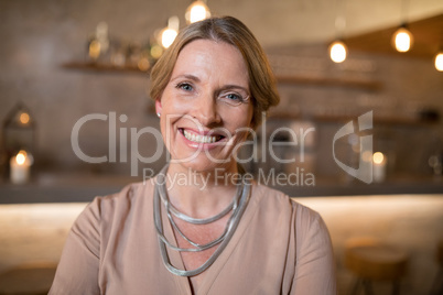 Portrait of beautiful woman standing in restaurant