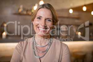 Portrait of beautiful woman standing in restaurant