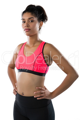 Confident young female athlete against white background