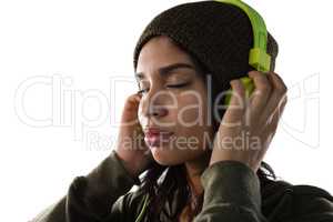 Young woman listening music on headphones