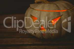 Close up of illuminated jack o lantern on table during Halloween