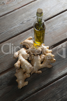 High angle view of gingers by oil bottle on table