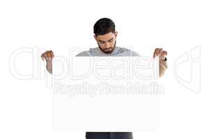 Handsome man looking at white blank sheet