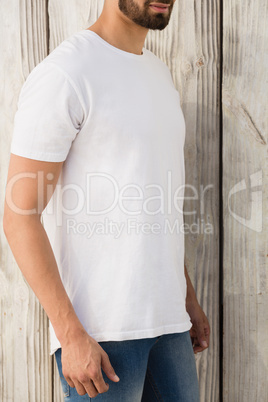 Man posing against wooden wall