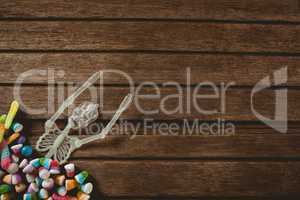 Skeleton decoration with candies on wooden table