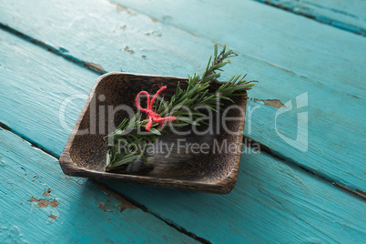 Tied rosemary in wooden bowl