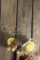 Overhead view of lemons with ginger tea on table