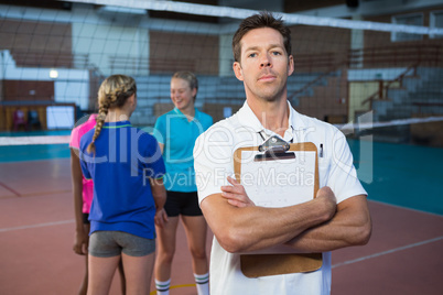 Confidence male coach standing in the court