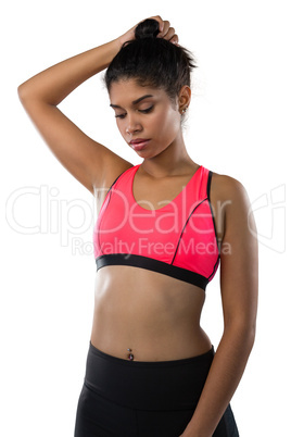 Female athlete with hand in hair against white background