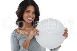 Portrait of smiling woman holding circle shaped placard